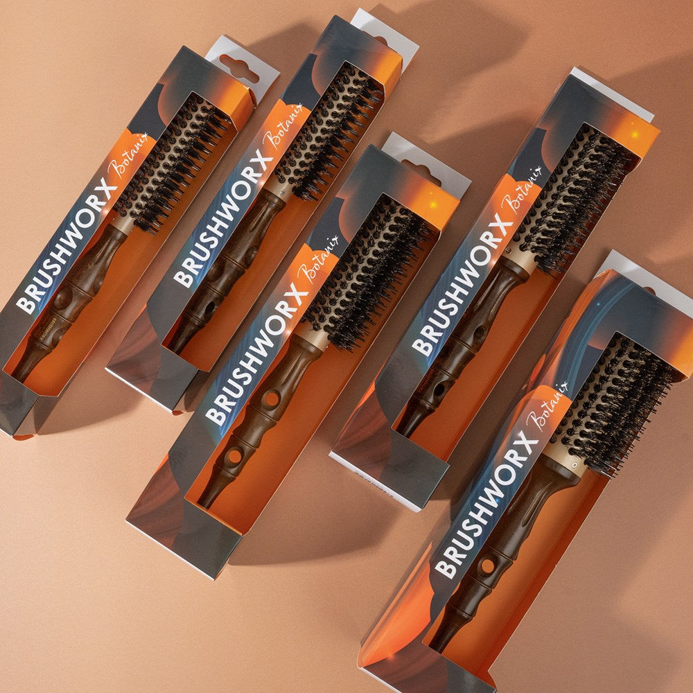Multiple BRUSHWORX hairbrushes in packaging on a beige background