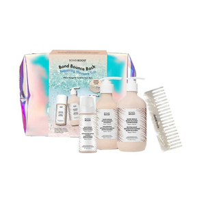 A hair care trio pack by Bondi Boost, including a bottle of bonding treatment, a bottle of bounce-back spray, and a bottle of repair serum, with a comb and packaging displaying the products and brand.