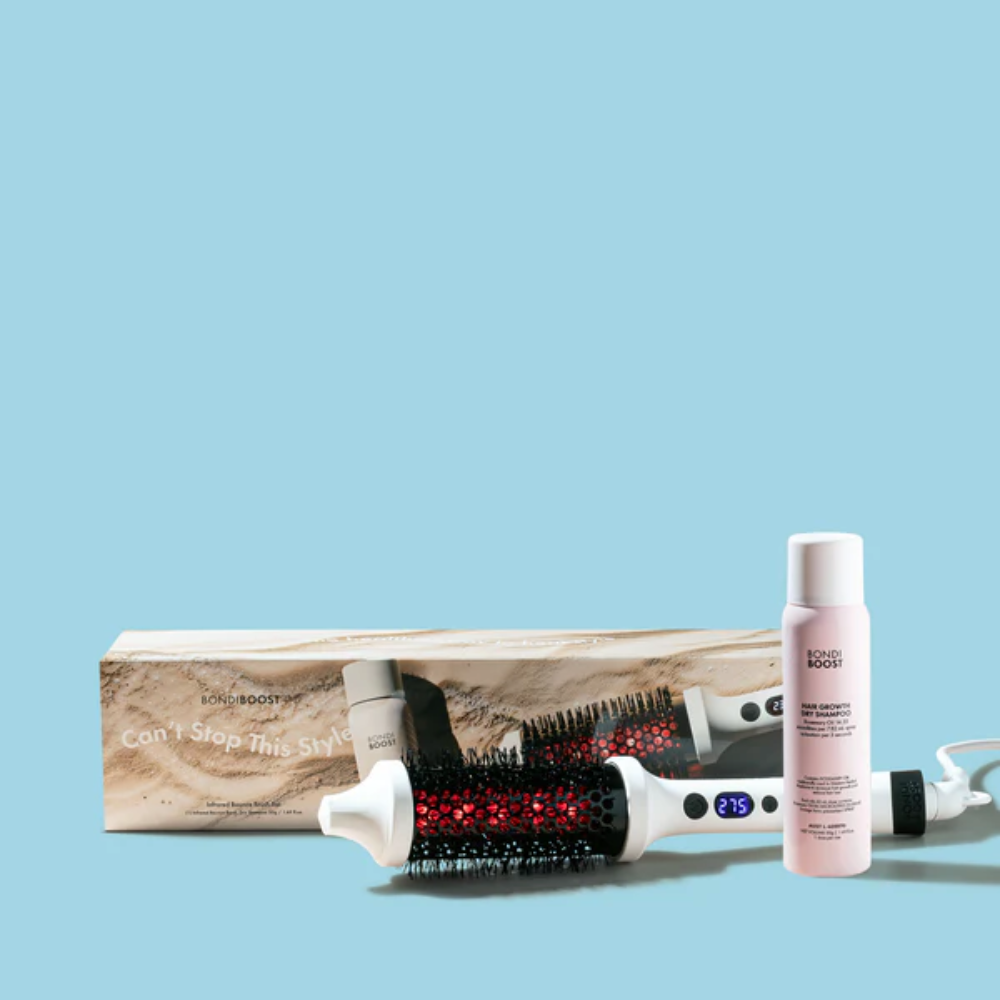 Hair styling tools including a brush, bottle, and box on a light blue background