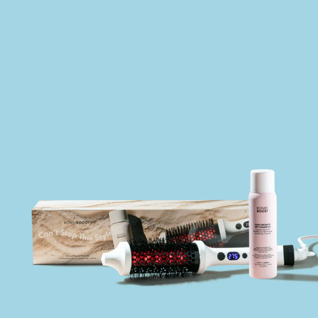 Hair styling tools including a brush, bottle, and box on a light blue background