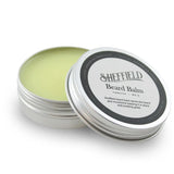 Sheffield beard balm container with lid open on a white background