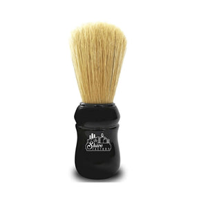 Shaving brush with black handle and blonde bristles on a white background